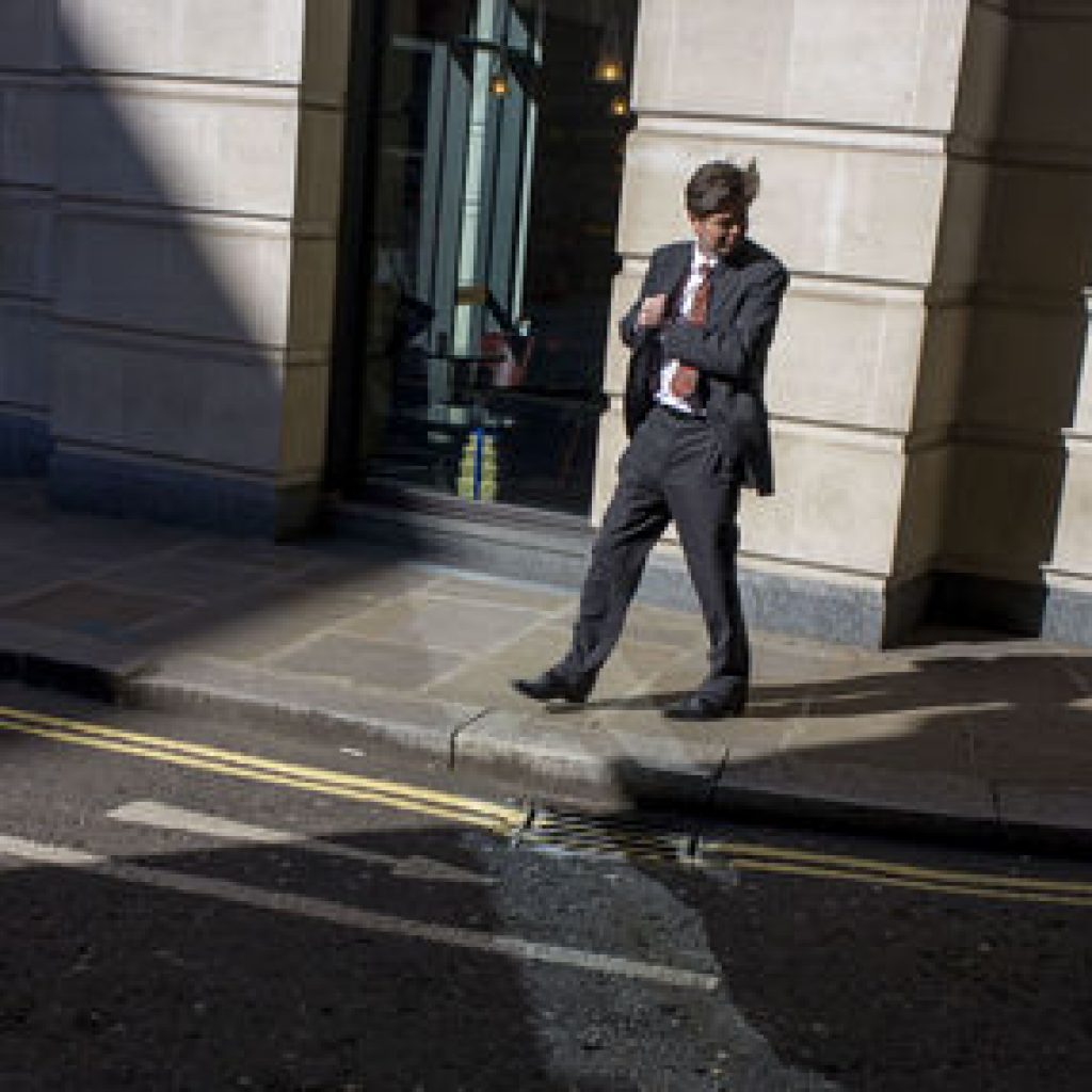 UK - London - Man reaching into jacket pocket